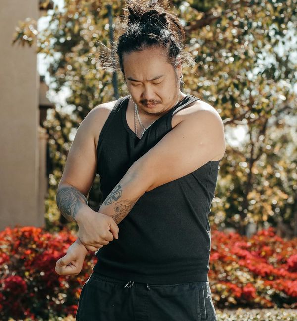 Person stretching outdoors, looking energized and full of vitality.